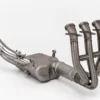 Stainless steel motorcycle exhaust system on white background.