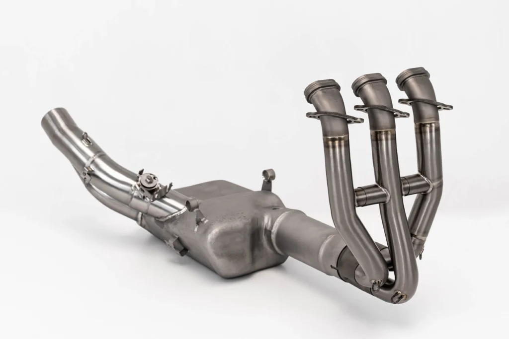 Stainless steel motorcycle exhaust system on white background.