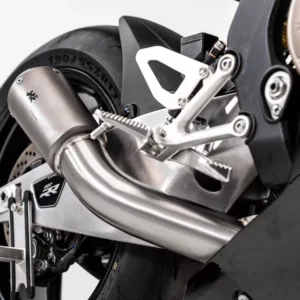 Close-up of motorcycle exhaust and rear wheel.