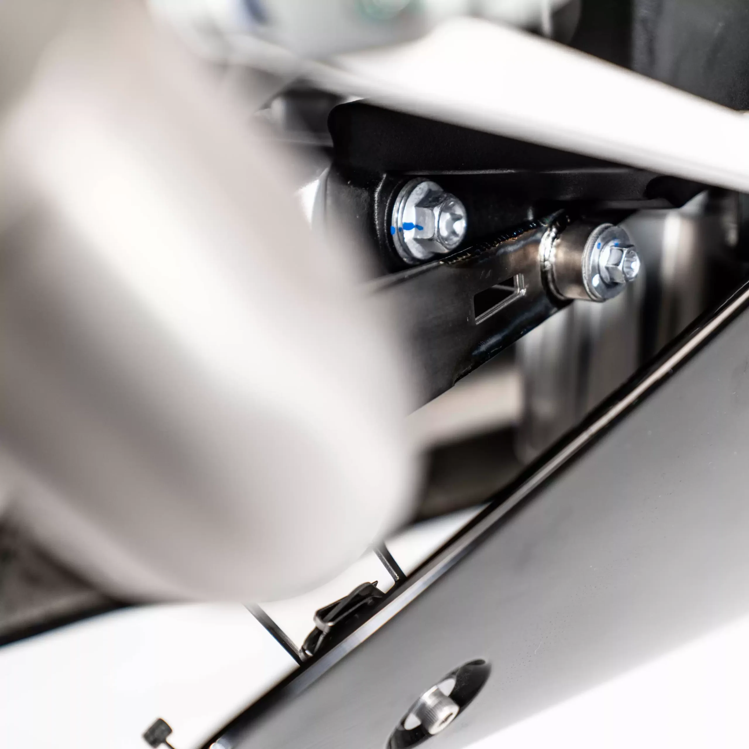 Close-up of motorcycle suspension bolts